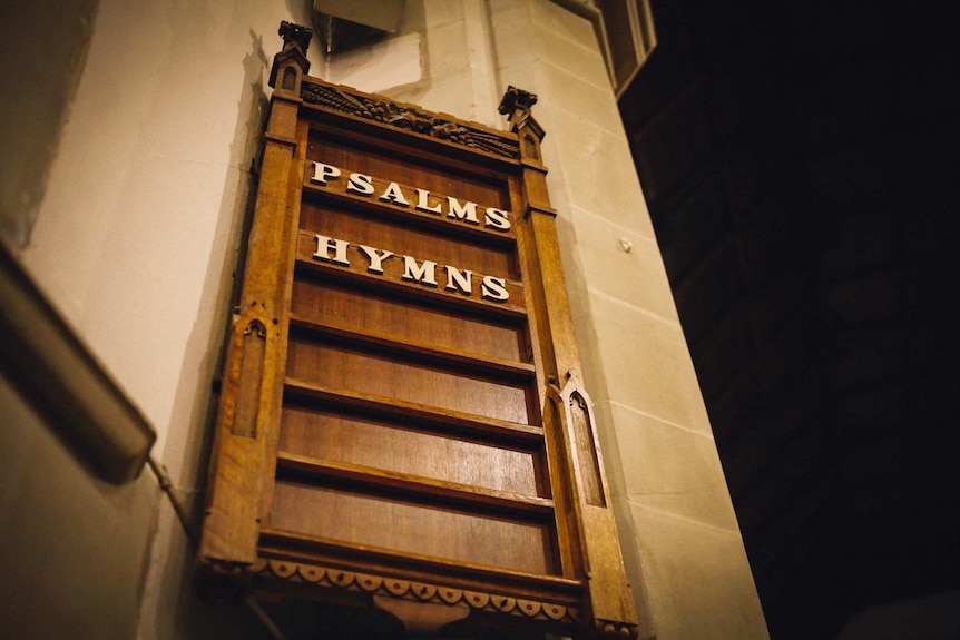 A board in a Uniting Church in Melbourne displaying the words "psalms" and "hymns".
