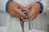 A doctor's hands holding a stethoscope.