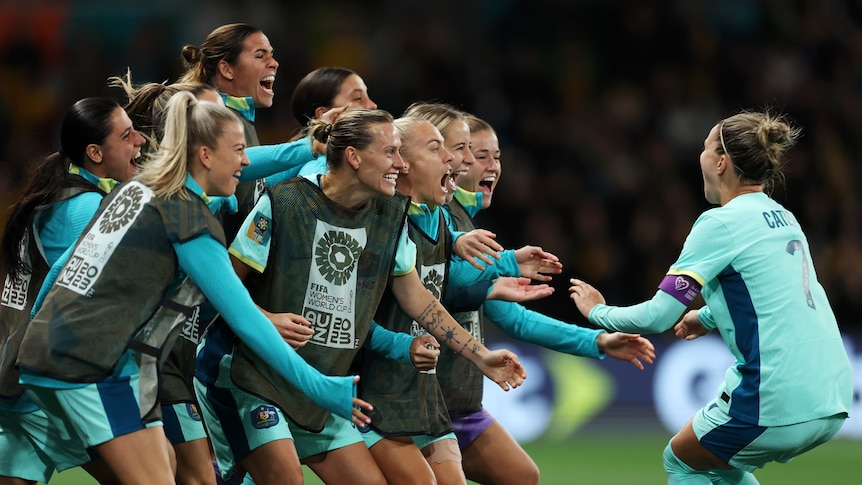 Steph Catley (1st R) of Australia celebrates with teammates after scoring her team's fourth goal 