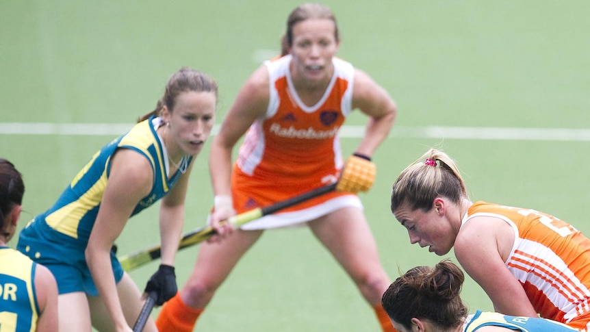 Scrambling defence ... Australia was under the cosh for much of the match as the Netherlands won 3-0.