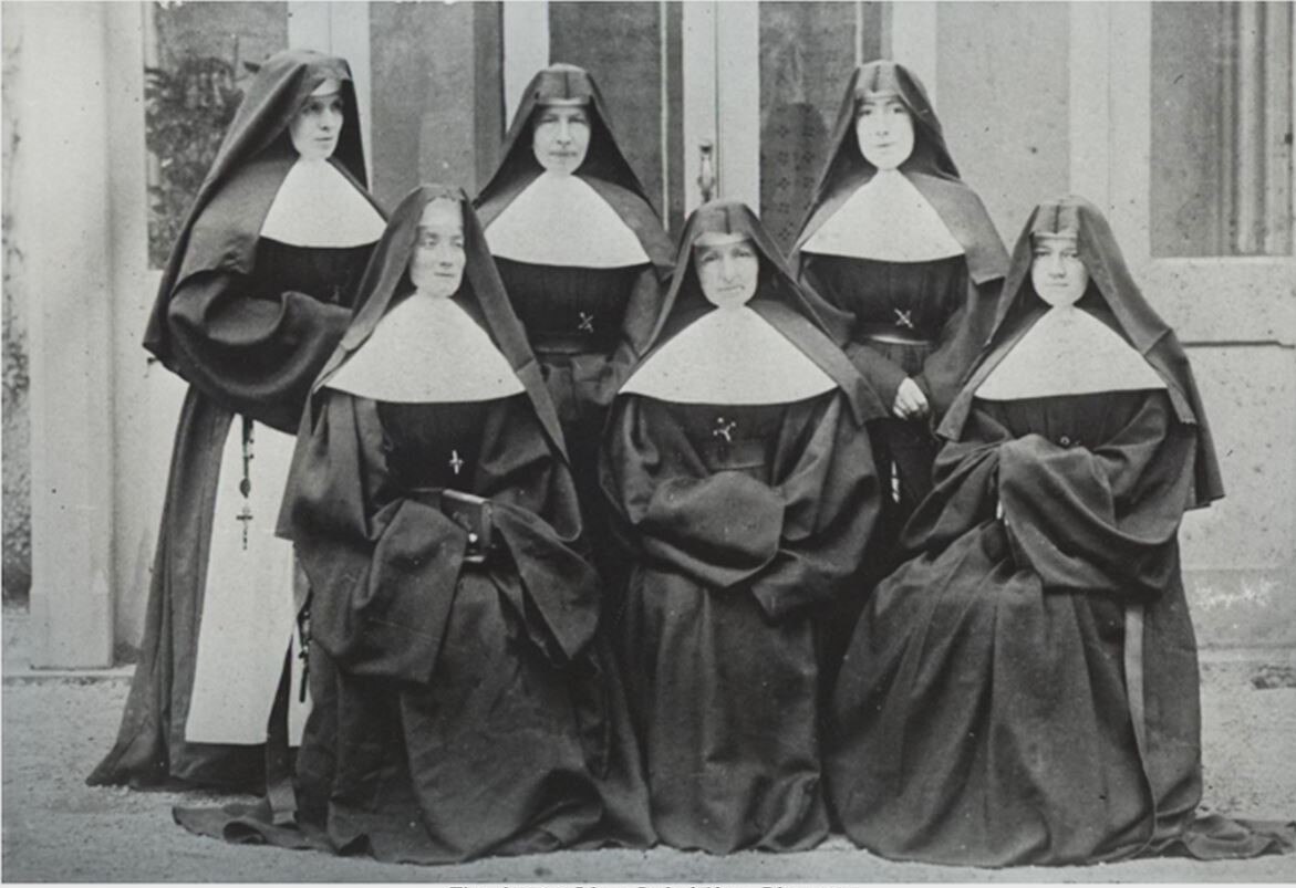 A black and white photo of six nuns in their habits