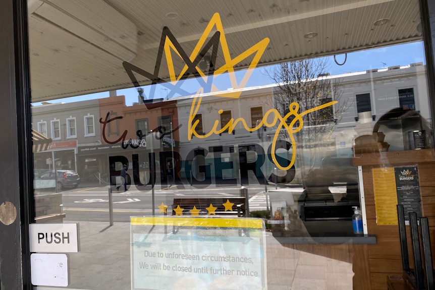 A closed until further notice sign on a burger shop