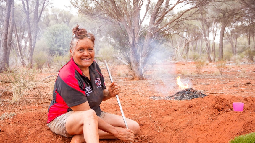 Margerie digging honey ants with her family at a special spot in the bush near Kalgoorlie.