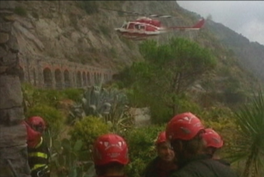 A helicopter assists in the rescue effort after the rock slide in Italy