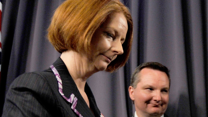 Prime Minister Julia Gillard leaves a press conference with Immigration Minister Chris Bowen