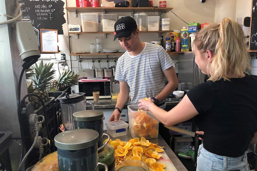 Brisbane cafe worker Alex Viller cutting up oranges
