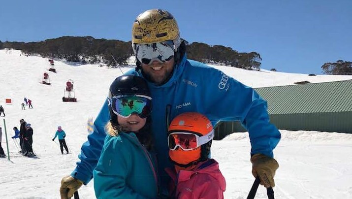 Ski instructor Phil O'Neil with two children he has been teaching on a ski slope.