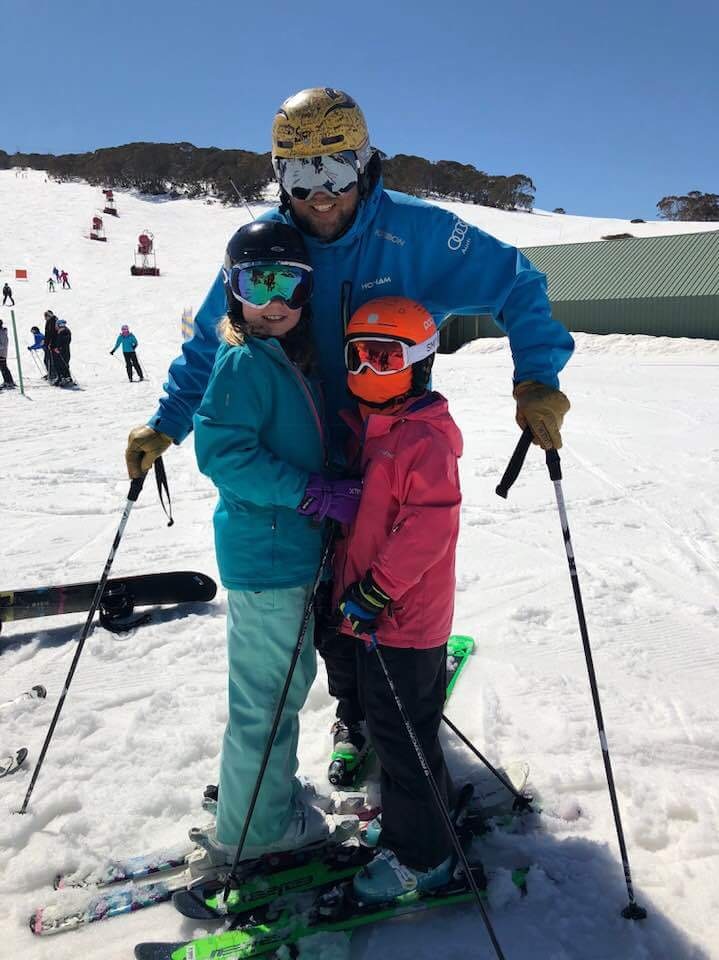 Ski instructor Phil O'Neil with two children he has been teaching on a ski slope.