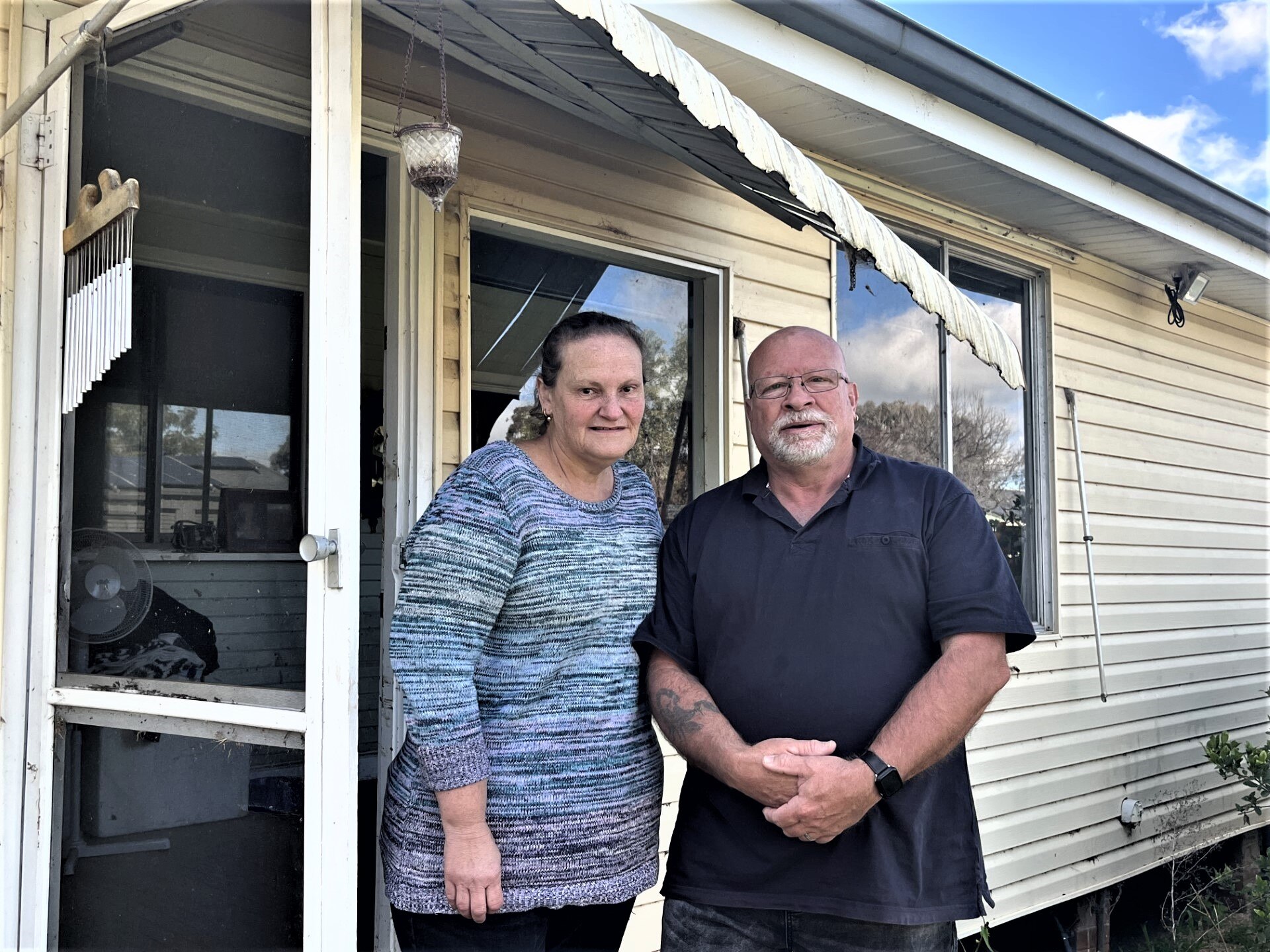 A man and a woman outside a house