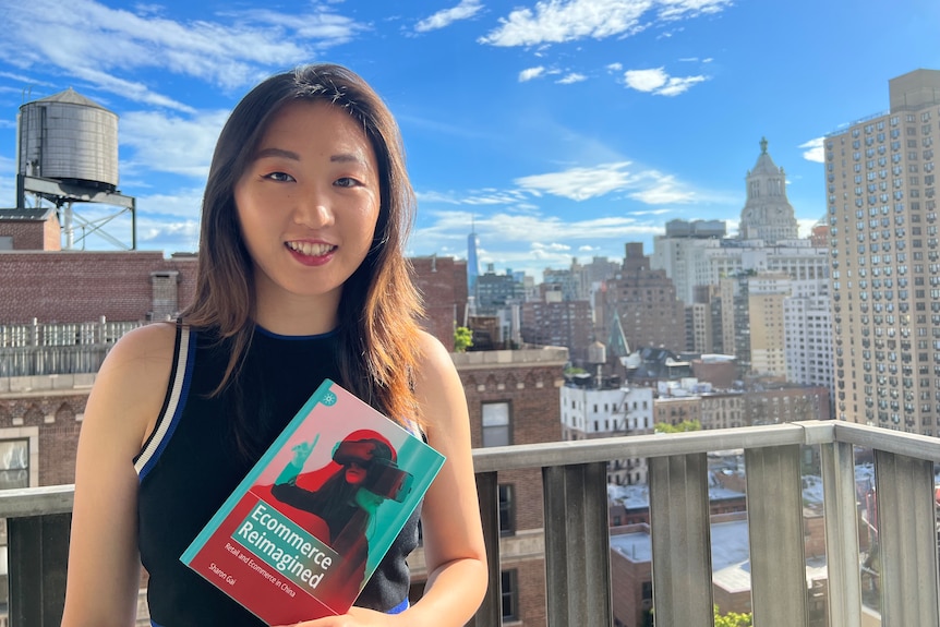 A young Chinese woman holding a book 