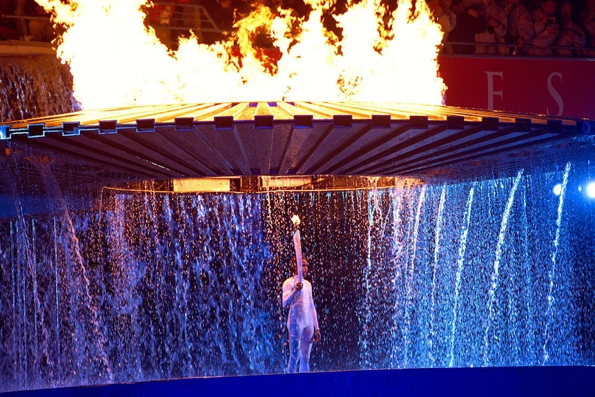 The Olympic cauldron rises over Australian athlete Cathy Freeman at the Opening Ceremony in Sydney.