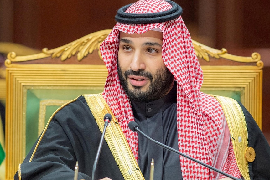 Mohammed bin Salman sitting on an ornate chair.