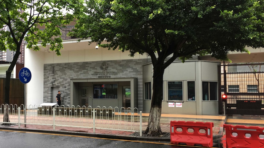 A security person walks outside the U.S. consulate building in Guangzhou.