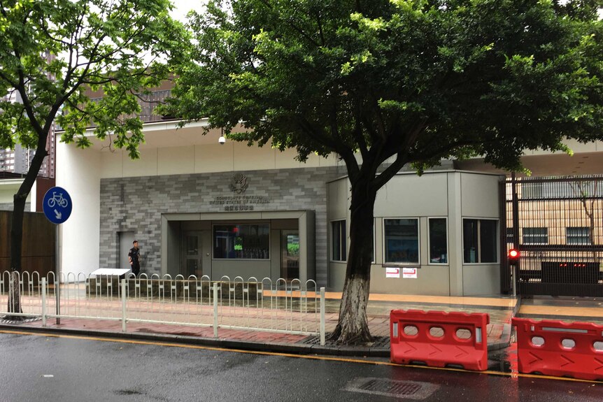 A security person walks outside the U.S. consulate building in Guangzhou.