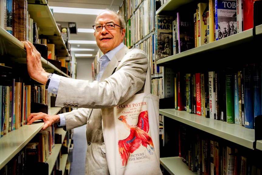 Nigel Newton of Bloomsbury stands in library.