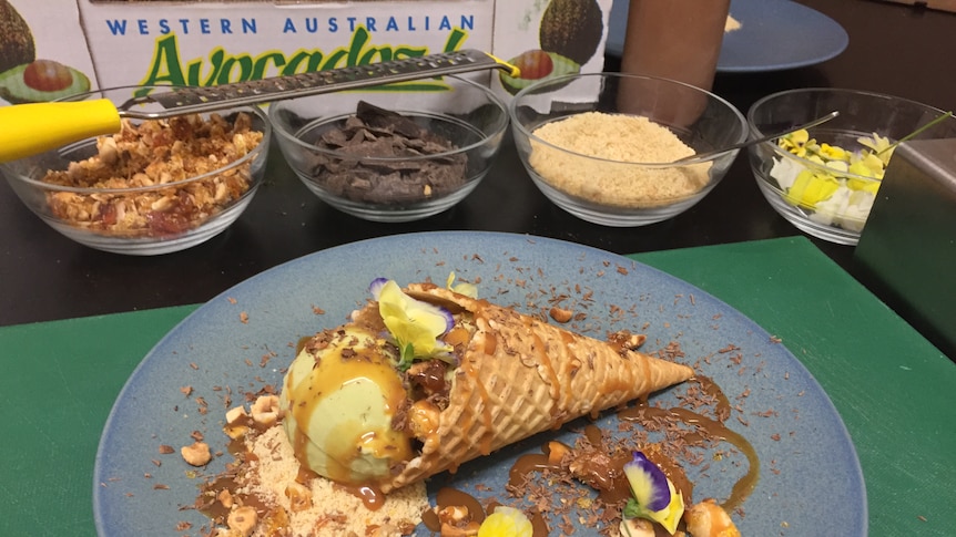 Display of ice cream in a cone with its ingredients like chocolate, praline and flowers