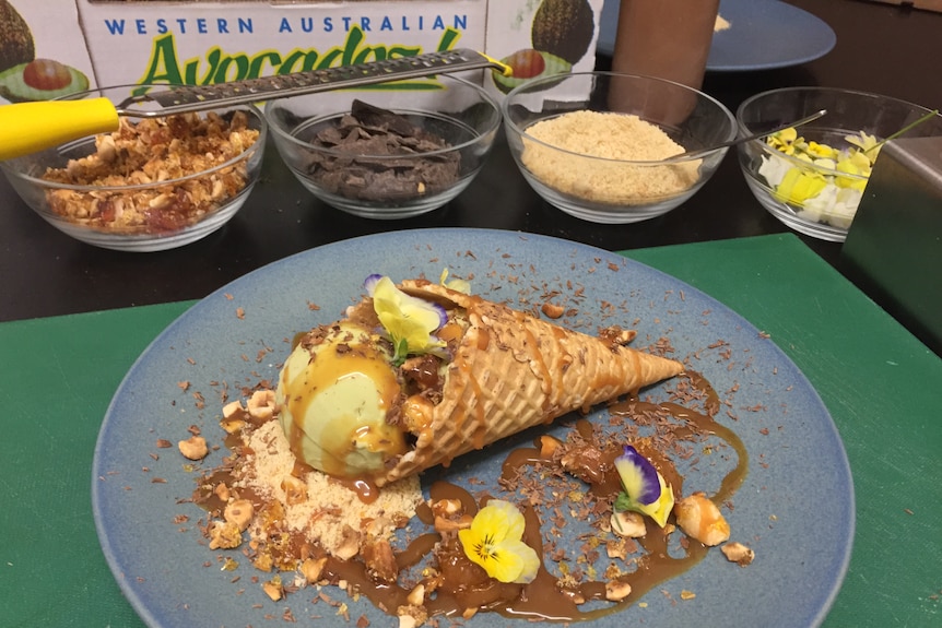 Display of ice cream in a cone with its ingredients like chocolate, praline and flowers