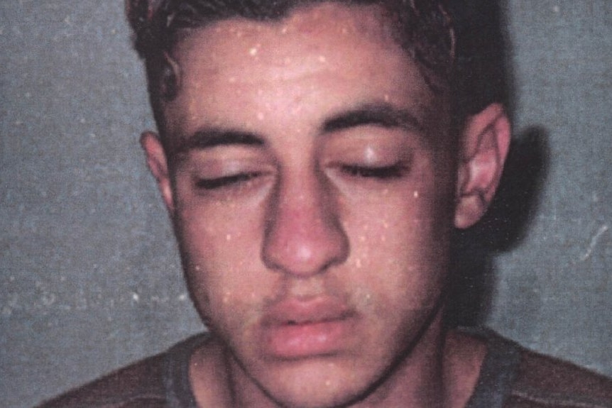 a young man with his eyes closed