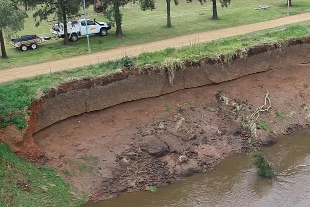 A heavily-eroded embankment collapsed into a river