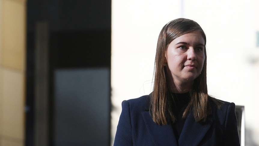 Brunette woman wearing dark suit