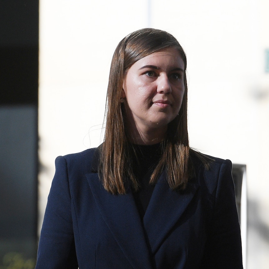 Brunette woman wearing dark suit