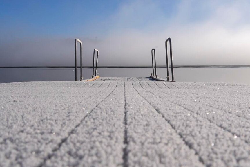 A frosty board with rails to a diving platform
