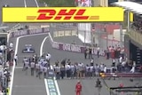 Esteban Ocon enters the pits with people in the pit lane at Baku