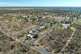 A drone photo of a small town showing houses and community buildings