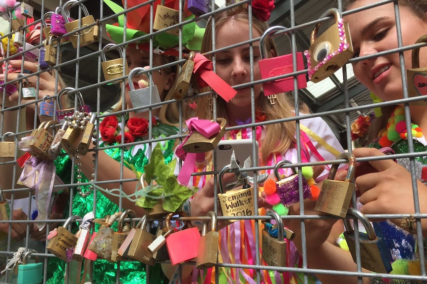 School leavers at St Aidan's in Brisbane lock a padlock to the school wall and throw away the key.