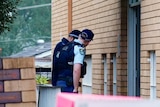 Police tape around an apartment