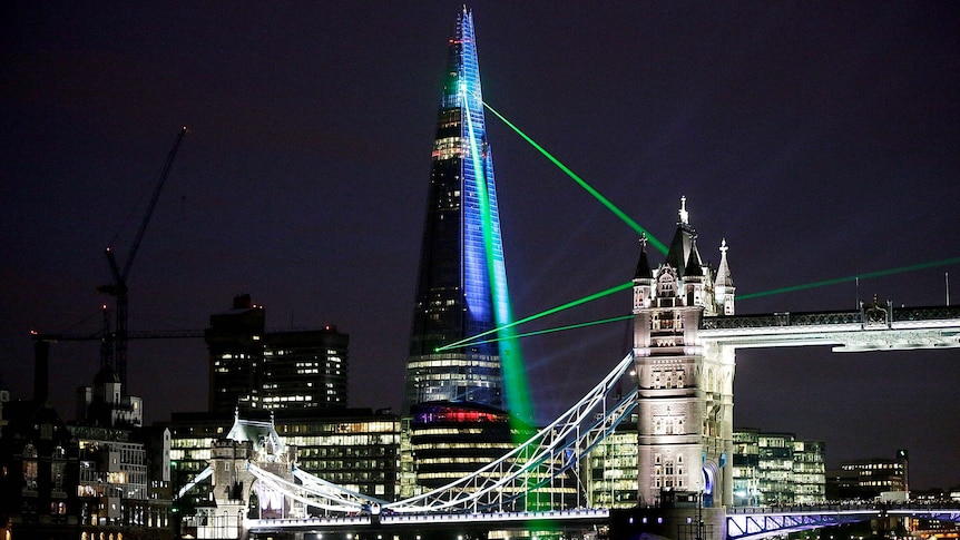 Lasers shine over Tower Bridge from the Shard in London.