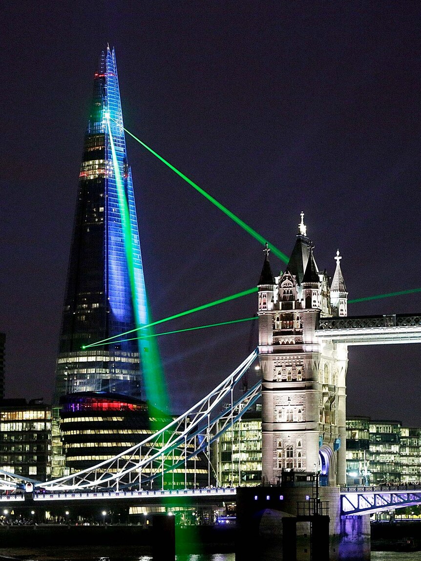 Lasers shine over Tower Bridge from the Shard in London.