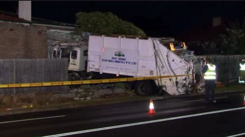 Garbage truck crashes into house