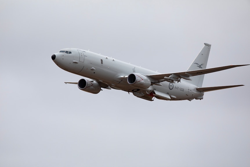 A P-8 Poseidon plane flies through the sky 