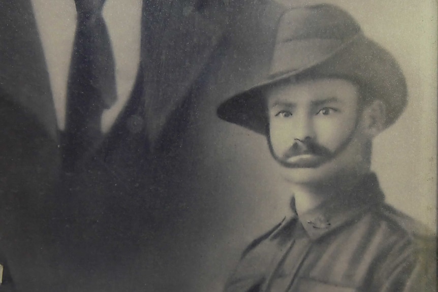 A black and white photo of a man with a moustache in military uniform