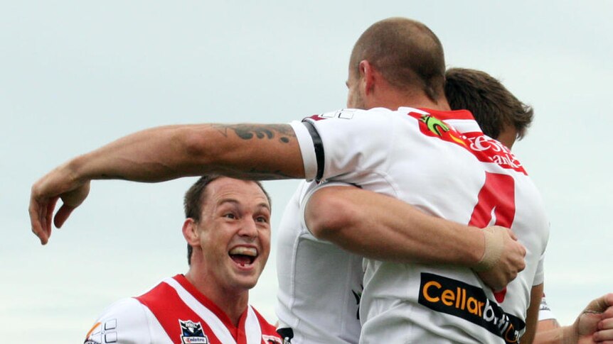 Top of the table ... the Dragons celebrate Matt Cooper's try.