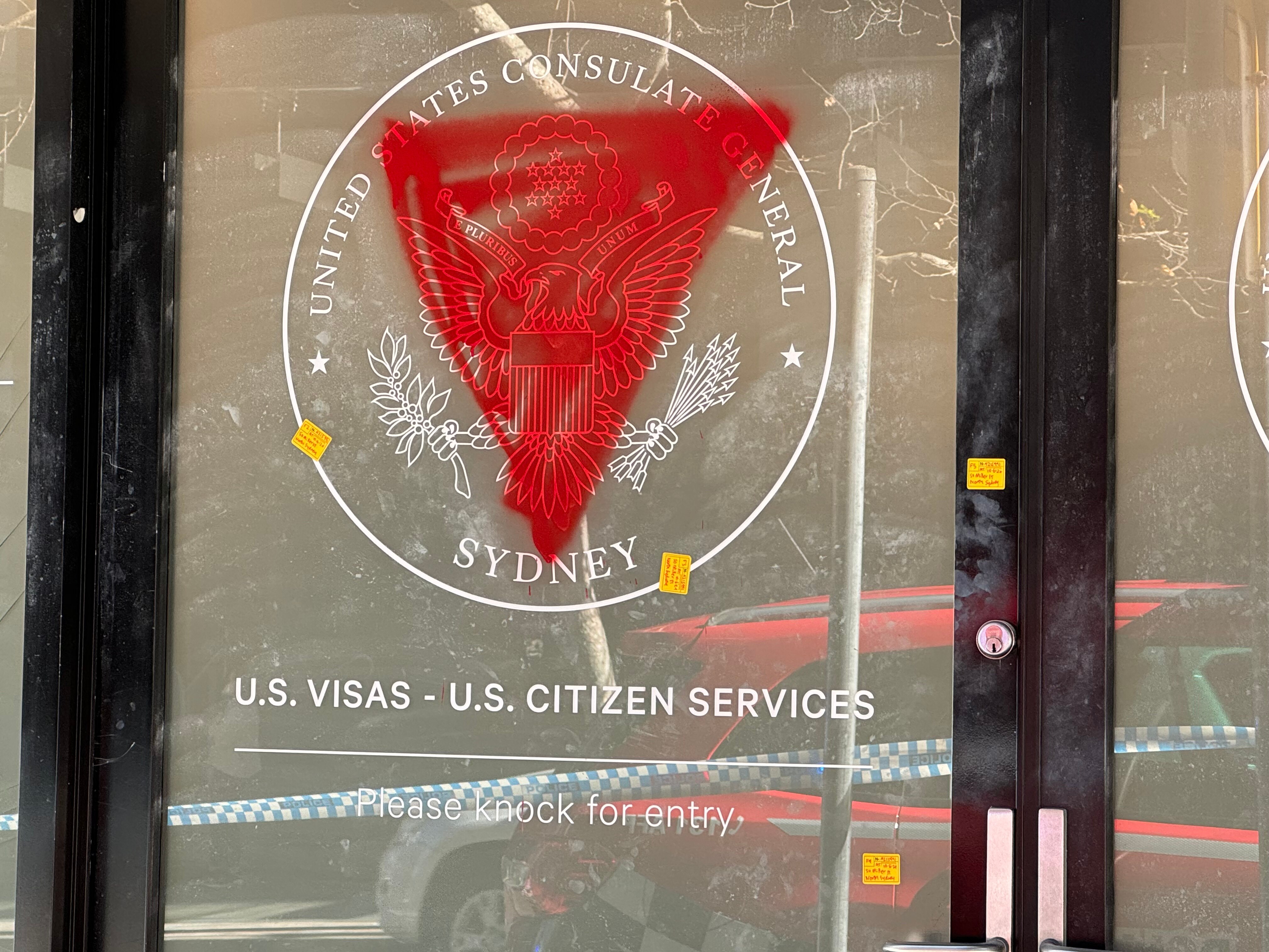 A US consulate in the city with its windows smashed and spray-painted with red triangles