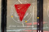 A US consulate in the city with its windows smashed and spray-painted with red triangles