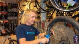 A man repairs a bike tire. 