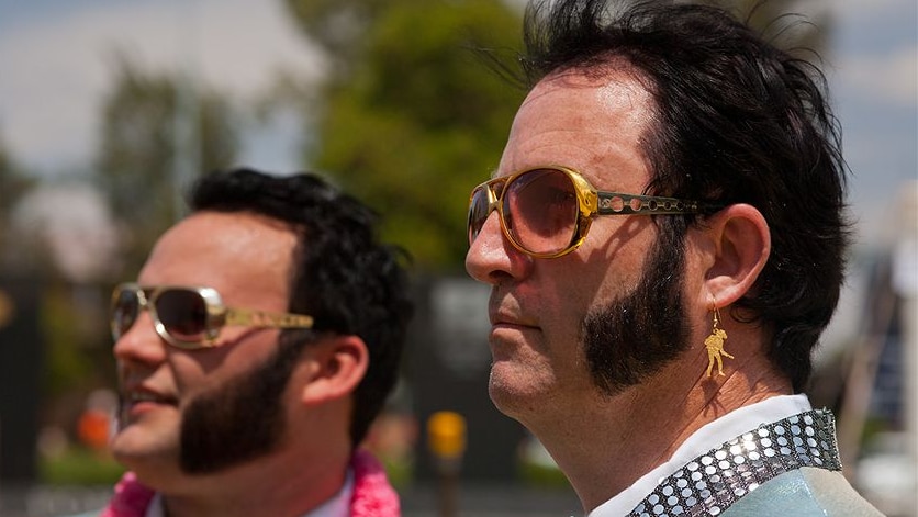 Man dressed as Elvis wearing Elvis Presley earring.