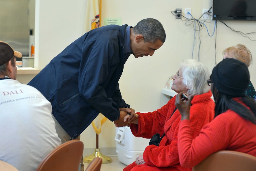 US president Barack Obama speaks with victims of superstorm Sandy at a shelter in Brigantine, New Jersey.