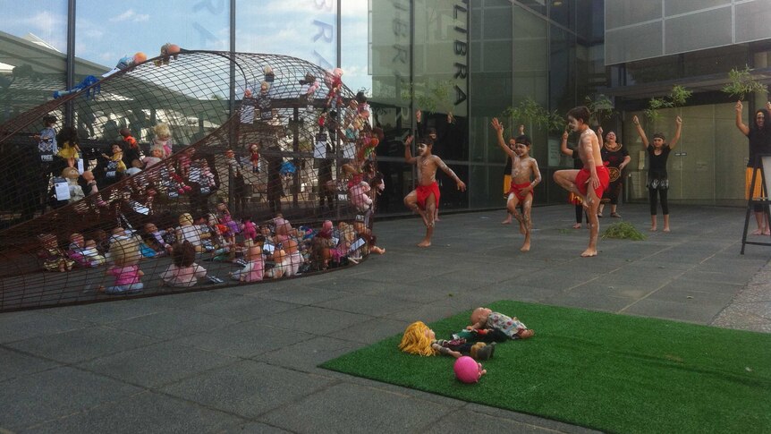 The Dulbinya dance group perform a 'Welcome to Country' at the front of the Wagga Wagga City Council building as part of an art installation focused on children in immigration detention centres