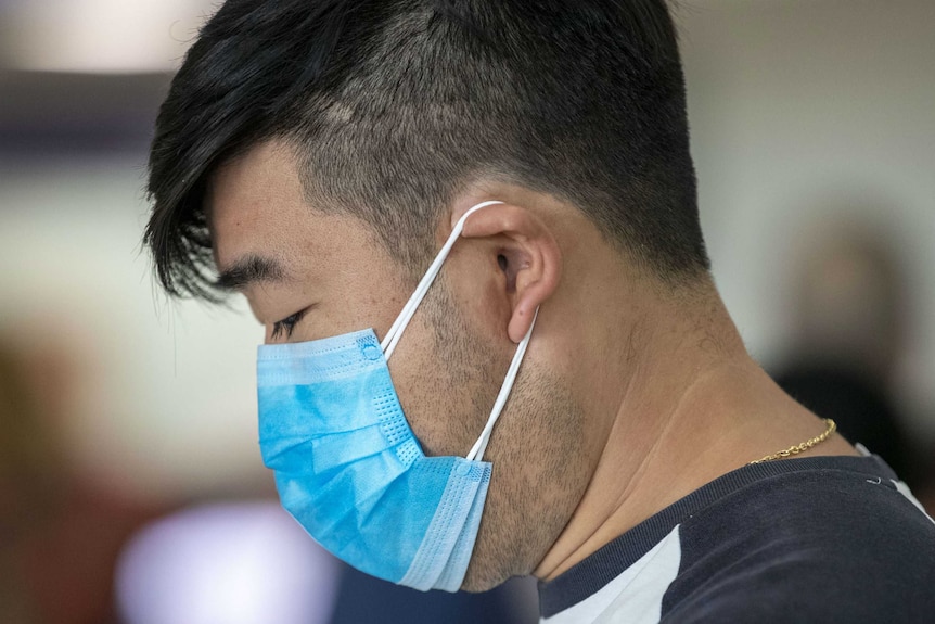 A person wearing a mask at Brisbane Airport.