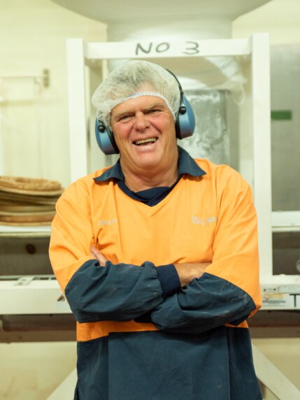 Man in hairnet and overalls laughing