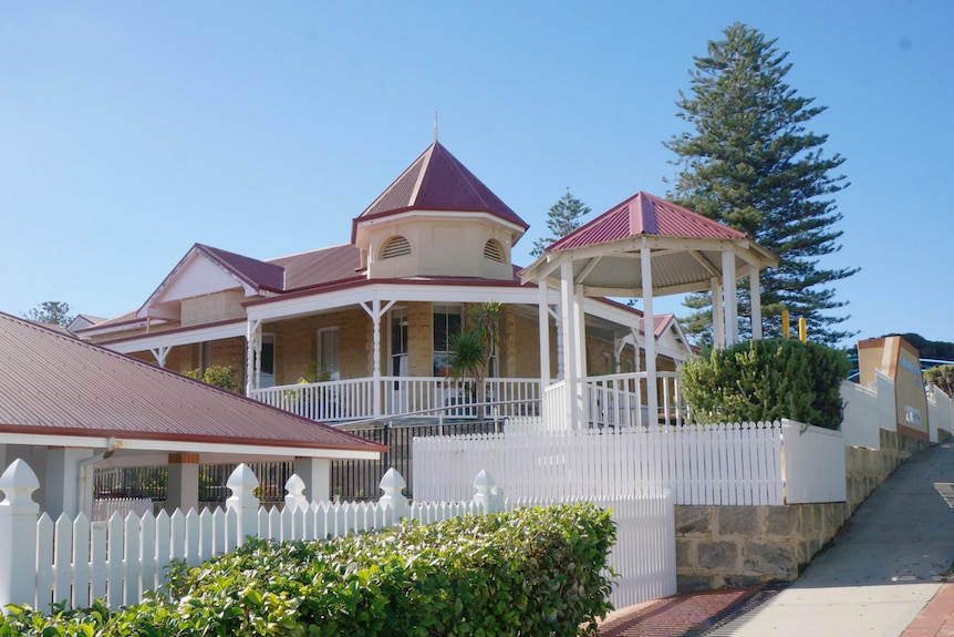 Lux house going up a hill with pine tree in background