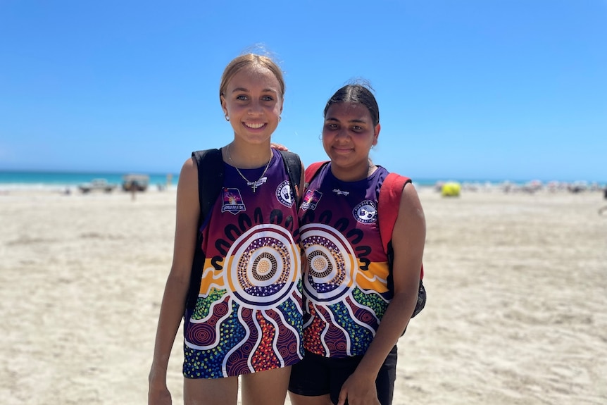 two girls smiling at camera 