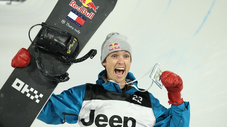 Scotty James holds a medal and smiles