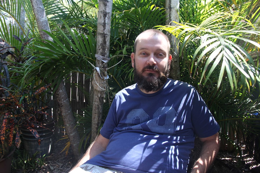 A man sitting in a garden