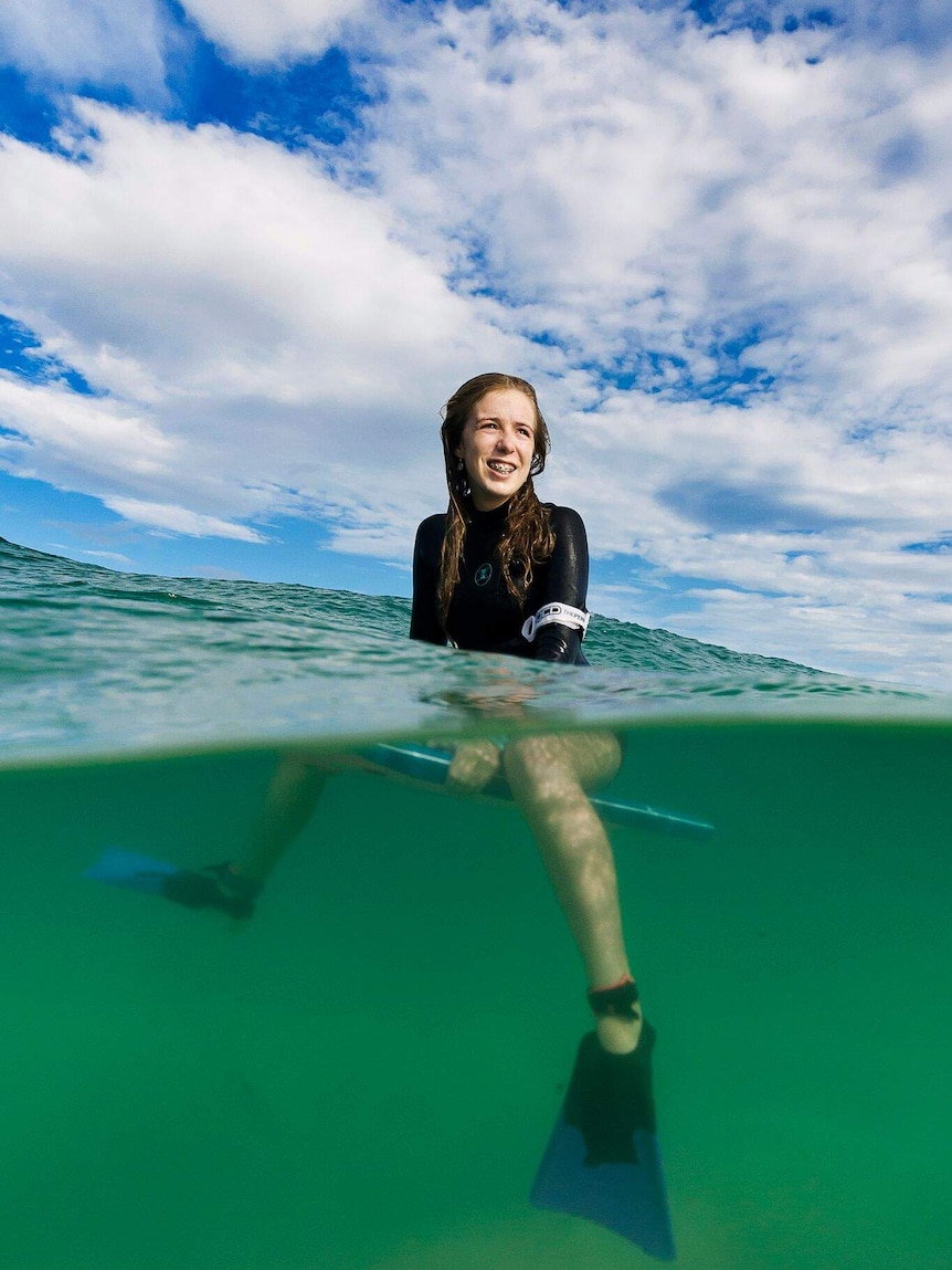 Bodyboarder Millie Chalker in the water, shot showing flippers and board.