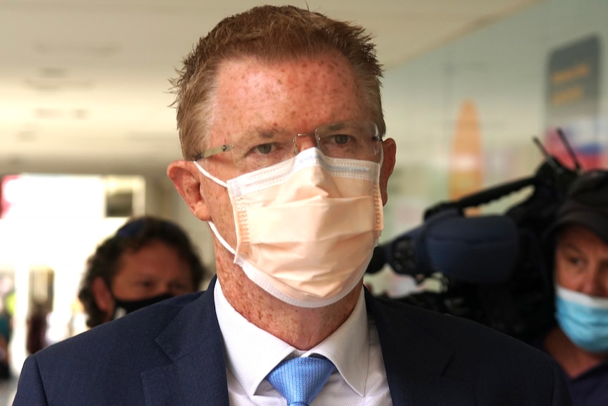 A tight head shot of Kempton Cowan wearing a face mask and spectacles.